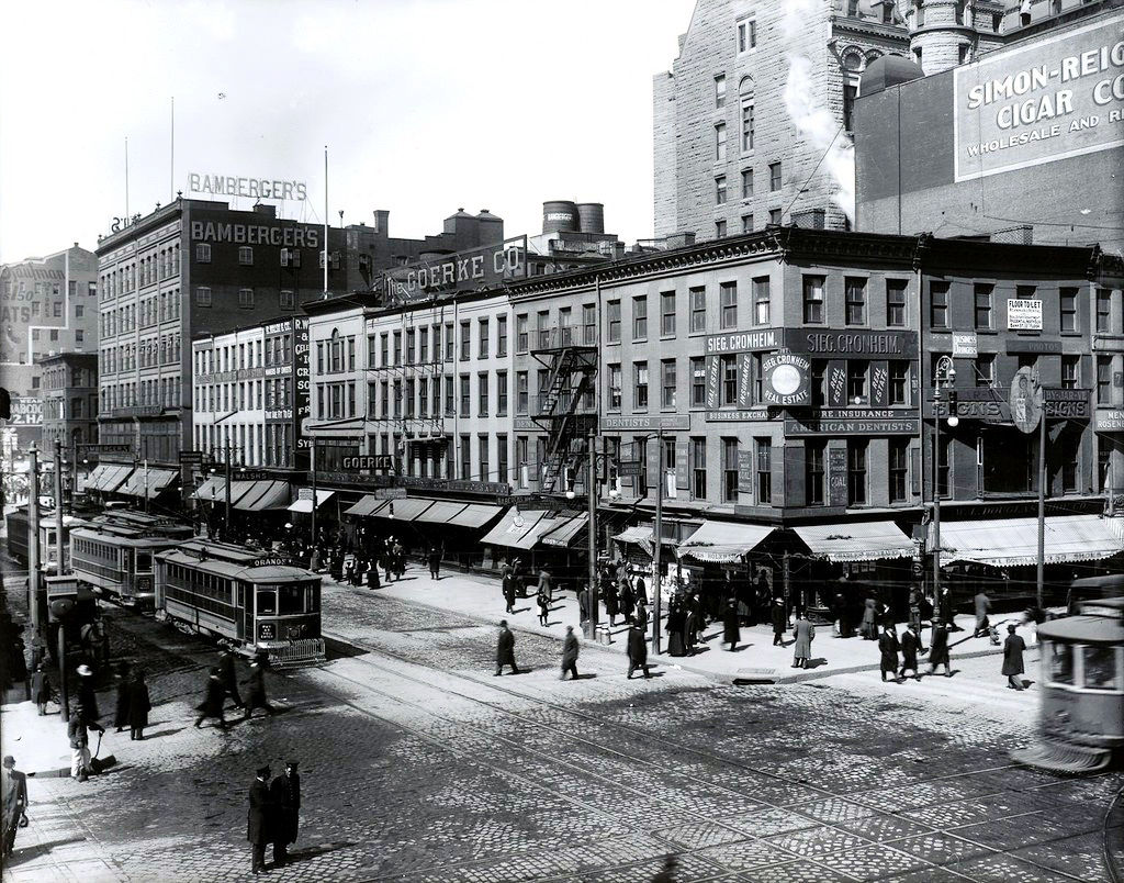 Broad & Market Streets
The northwest corner of Broad & Market Streets from the George Conrad Collection.  The original Goerke Co. department store, which later moved to the northwest corner of Broad & Cedar Streets before burning down at that location (replaced by McCrory's and now a Nike store). The original expanded Bamberger's Department store stands at the northeast corner of Market & Halsey Streets and the shorter building past that, on the northwest corner, is their annex store.  The building all the way to the left with "ATS" on the side is the Metropolitan building.  The second Bamberger's would be built on that block, around the Metropolitan building and eventually the Metropolitan building would be taken down and Bamberger's expanded into that corner.  The entire northwest corner would be demolished, including the large building on the right with the cigar sign to make the Woolworth's building and the corner building which still stands, minus the corner tower.
